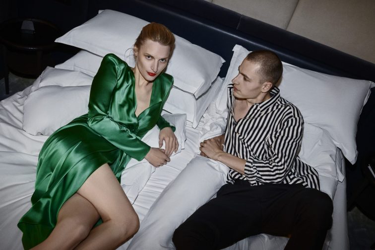 <couple in bed wearing fancy outfits after a night out