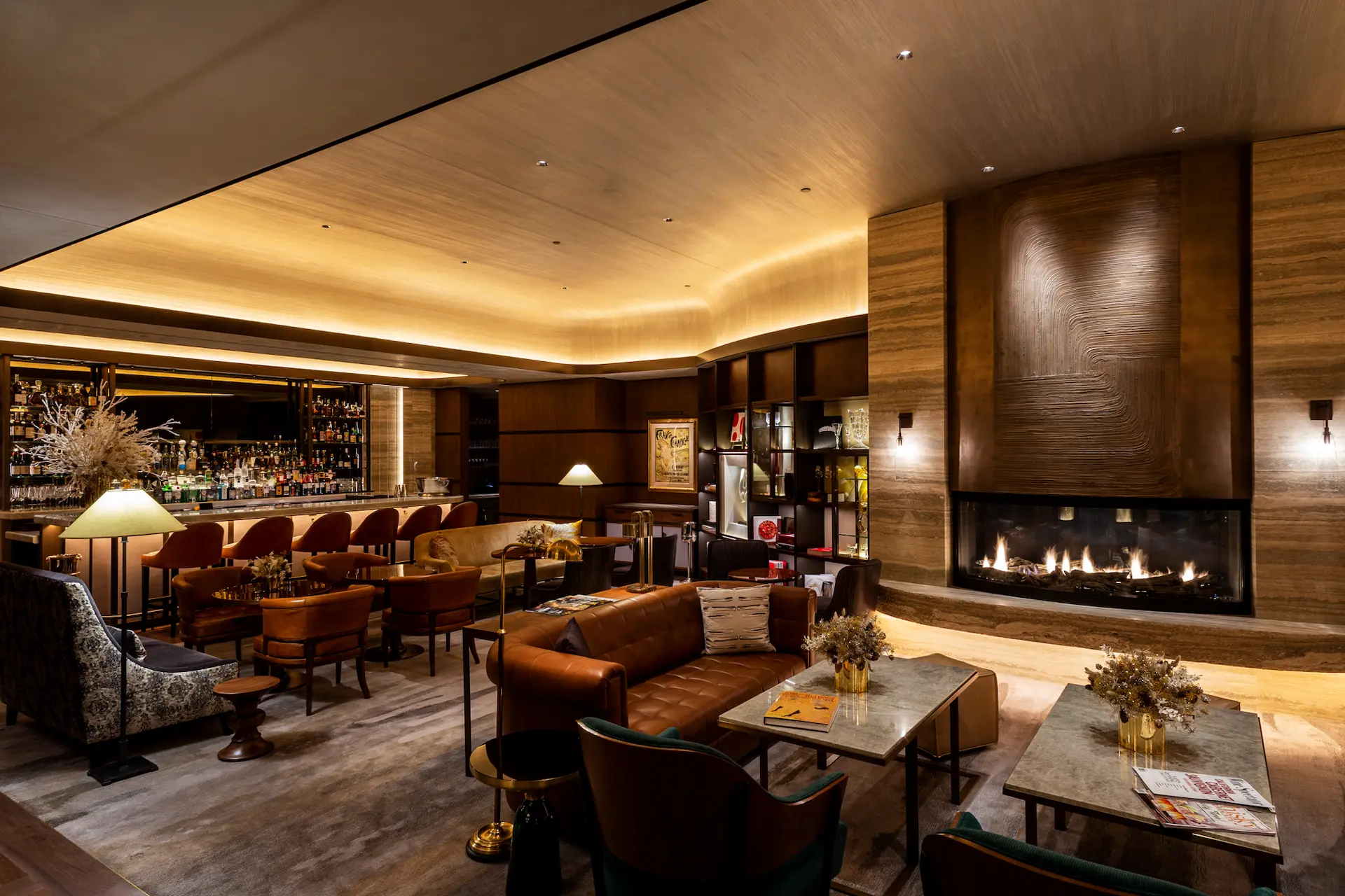 <seating, fireplace and bar at private club area of WS New York