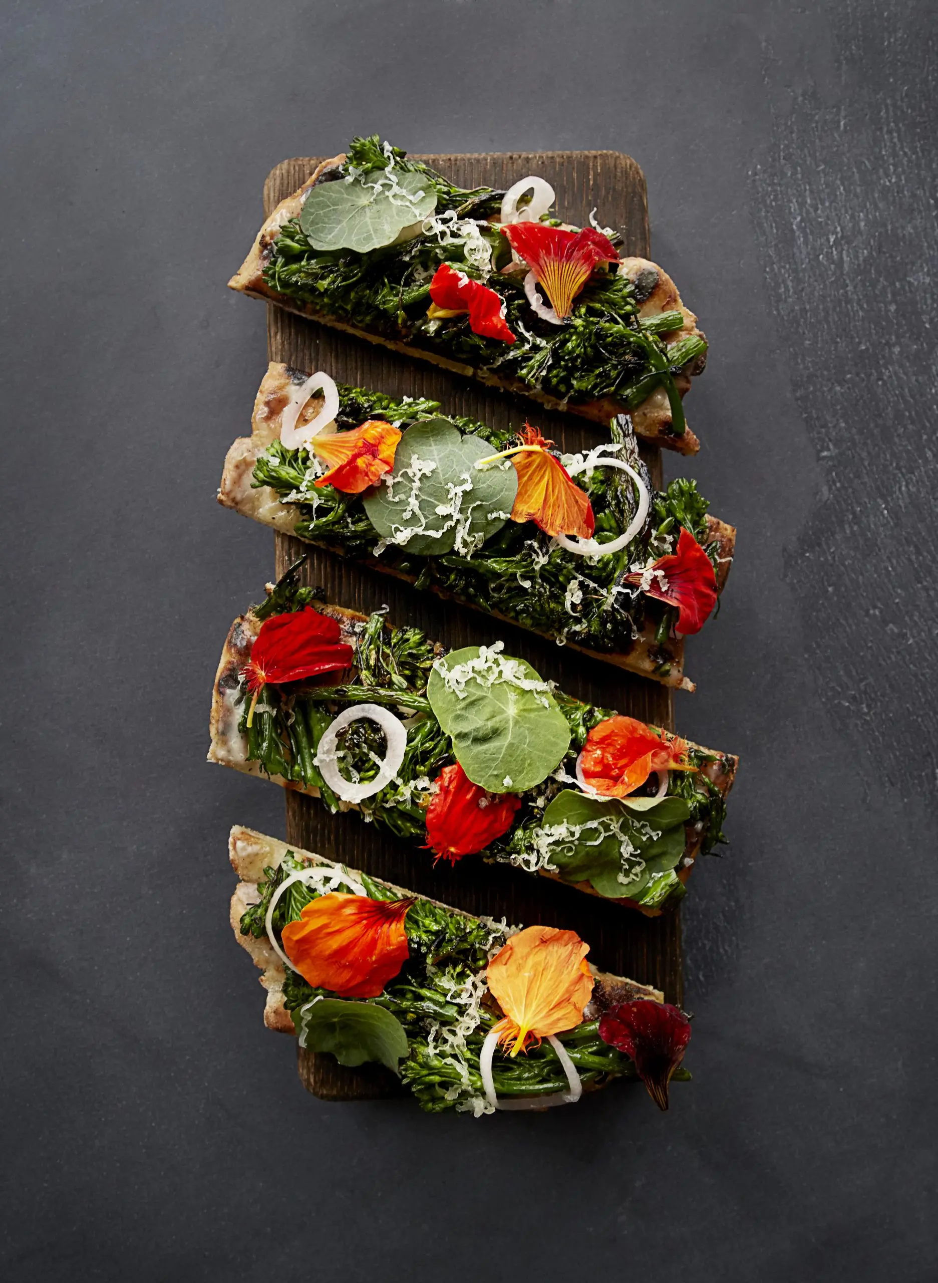 <broccoli rabe flatbread on wooden board