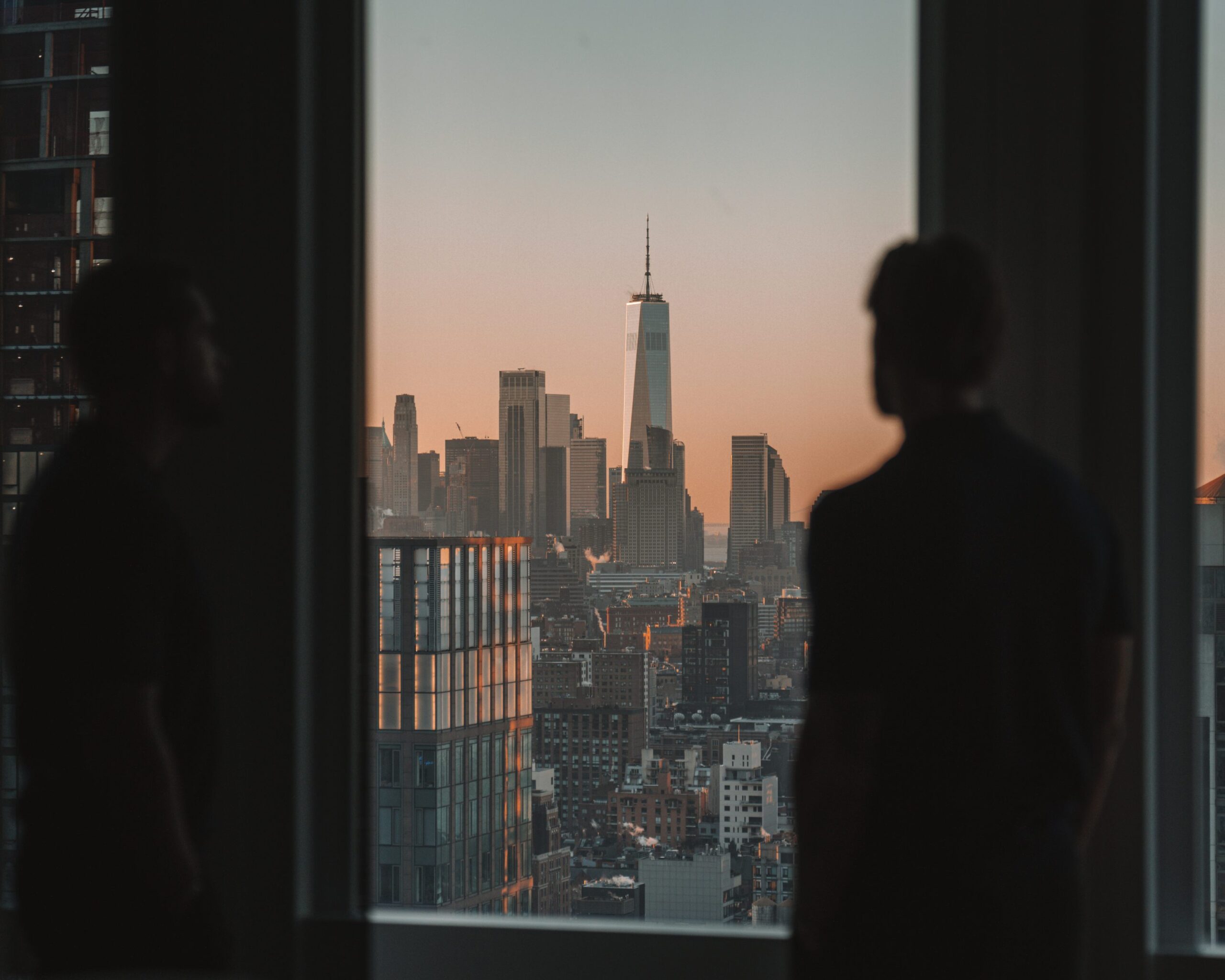 A man admiring Manhattan through a window