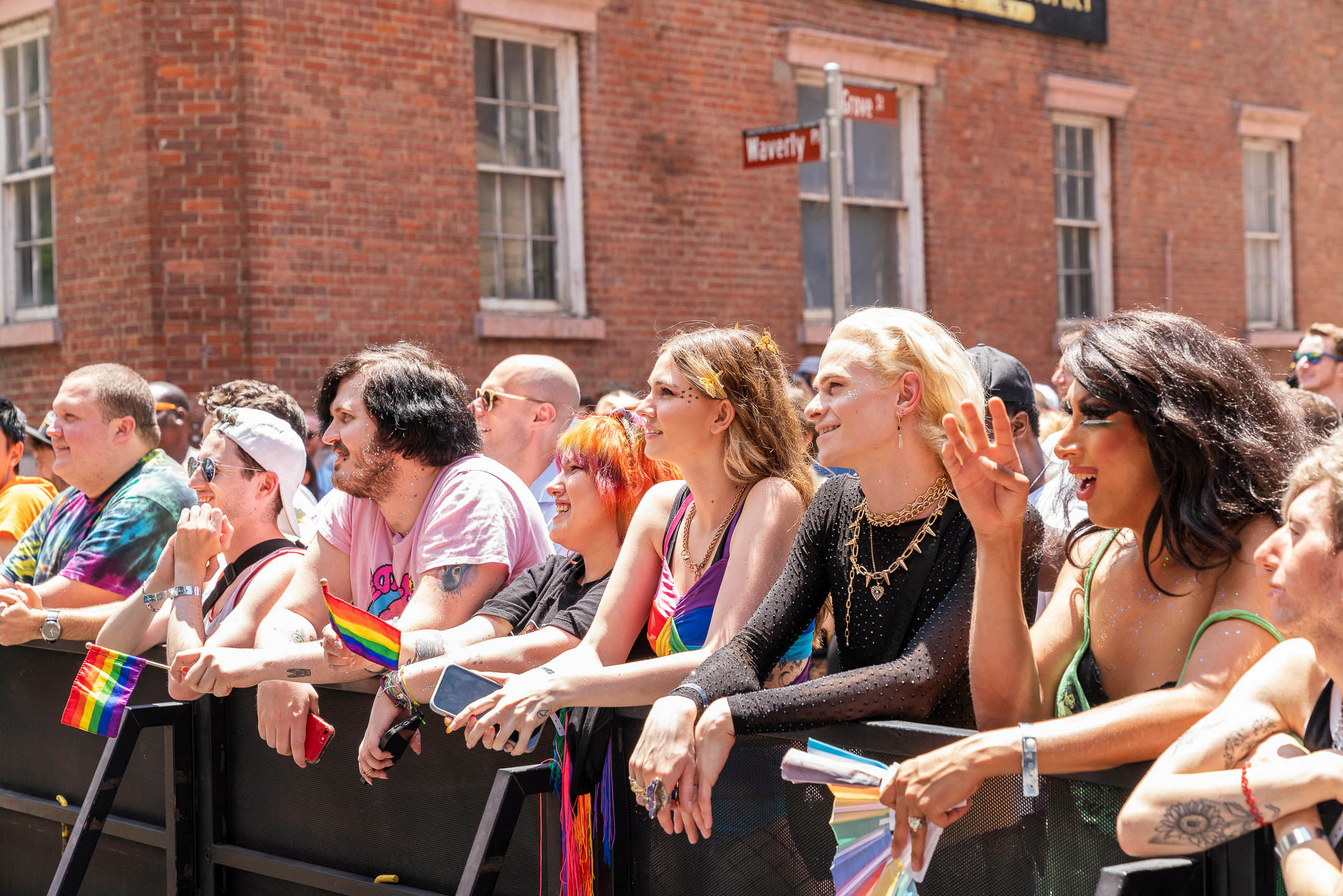 A group of people watching the float during the gay pride