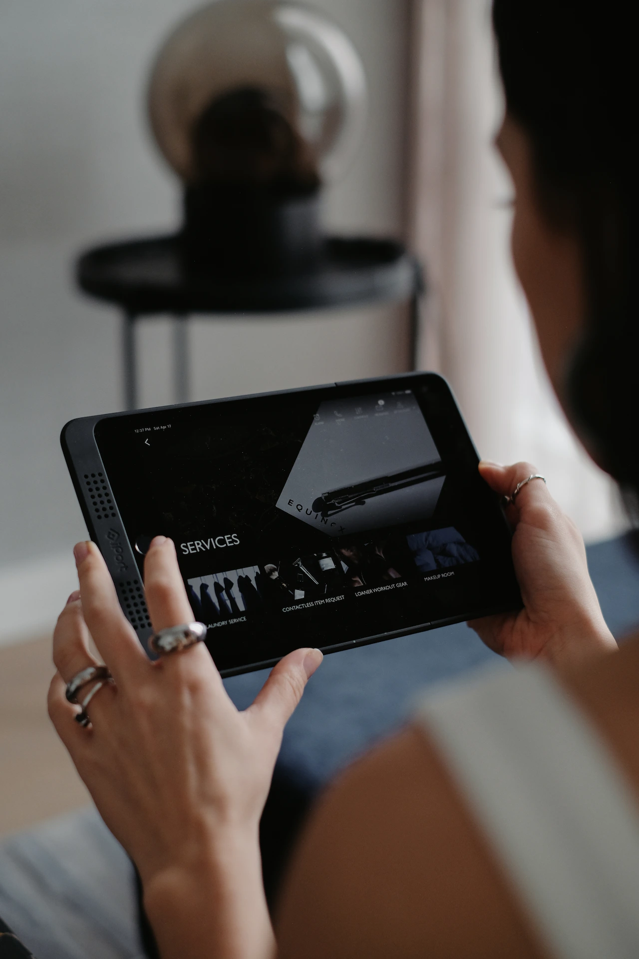 Person using a tablet, viewing content about a luxury hotel experience.