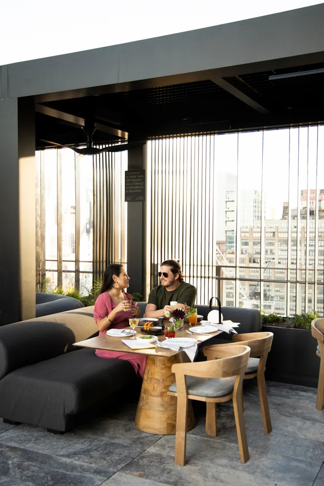 <Couple enjoying in the equinox outdoor rooftop terrace electriclemon