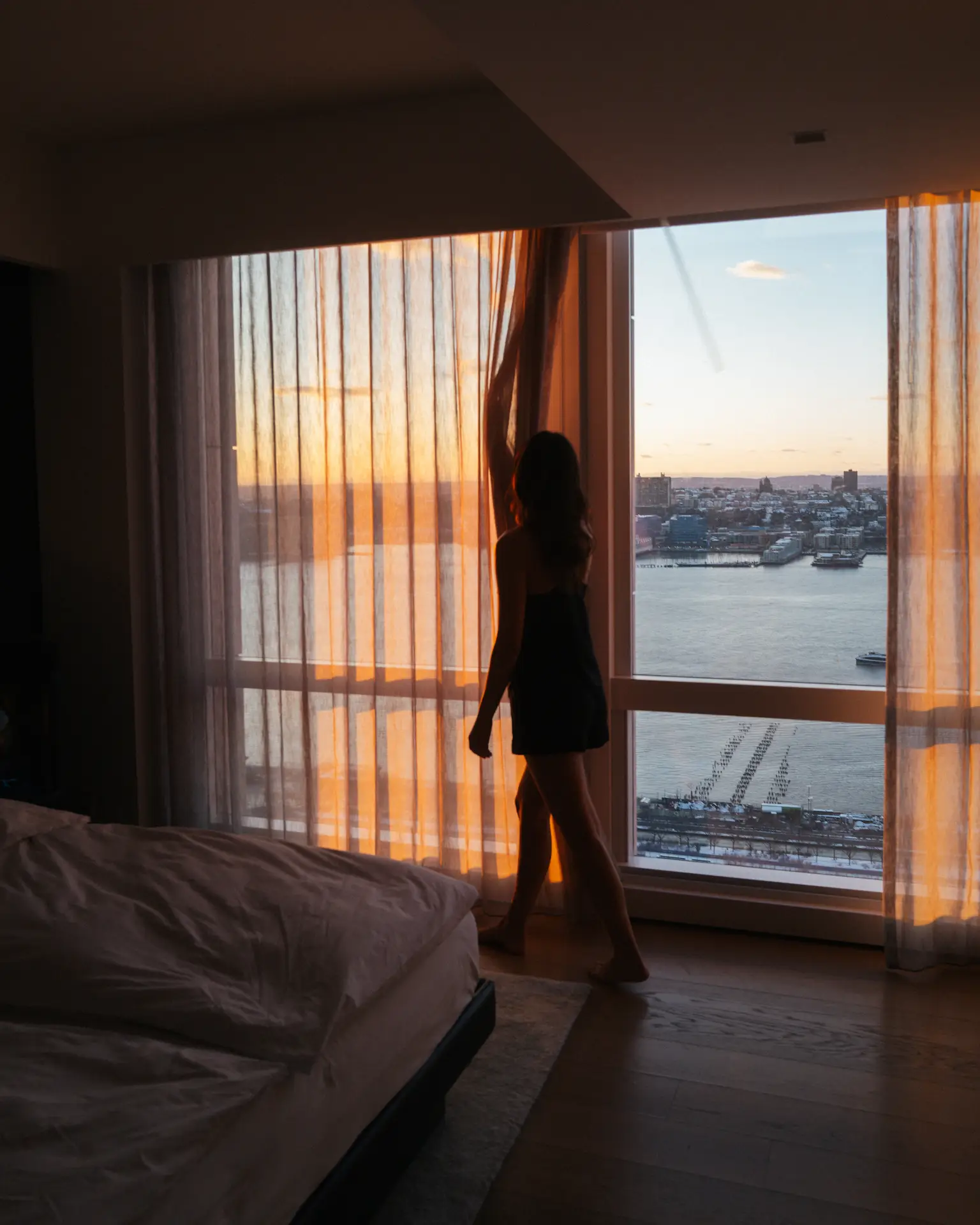 Woman moving curtains in the room